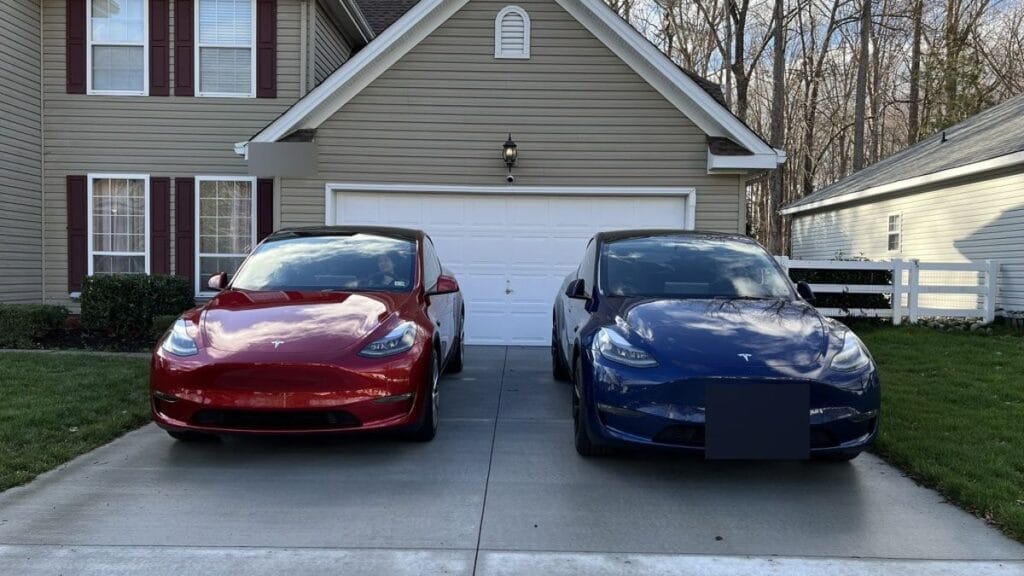 Cost to charge a Tesla — two Tesla Model Ys charged at home in the driveway