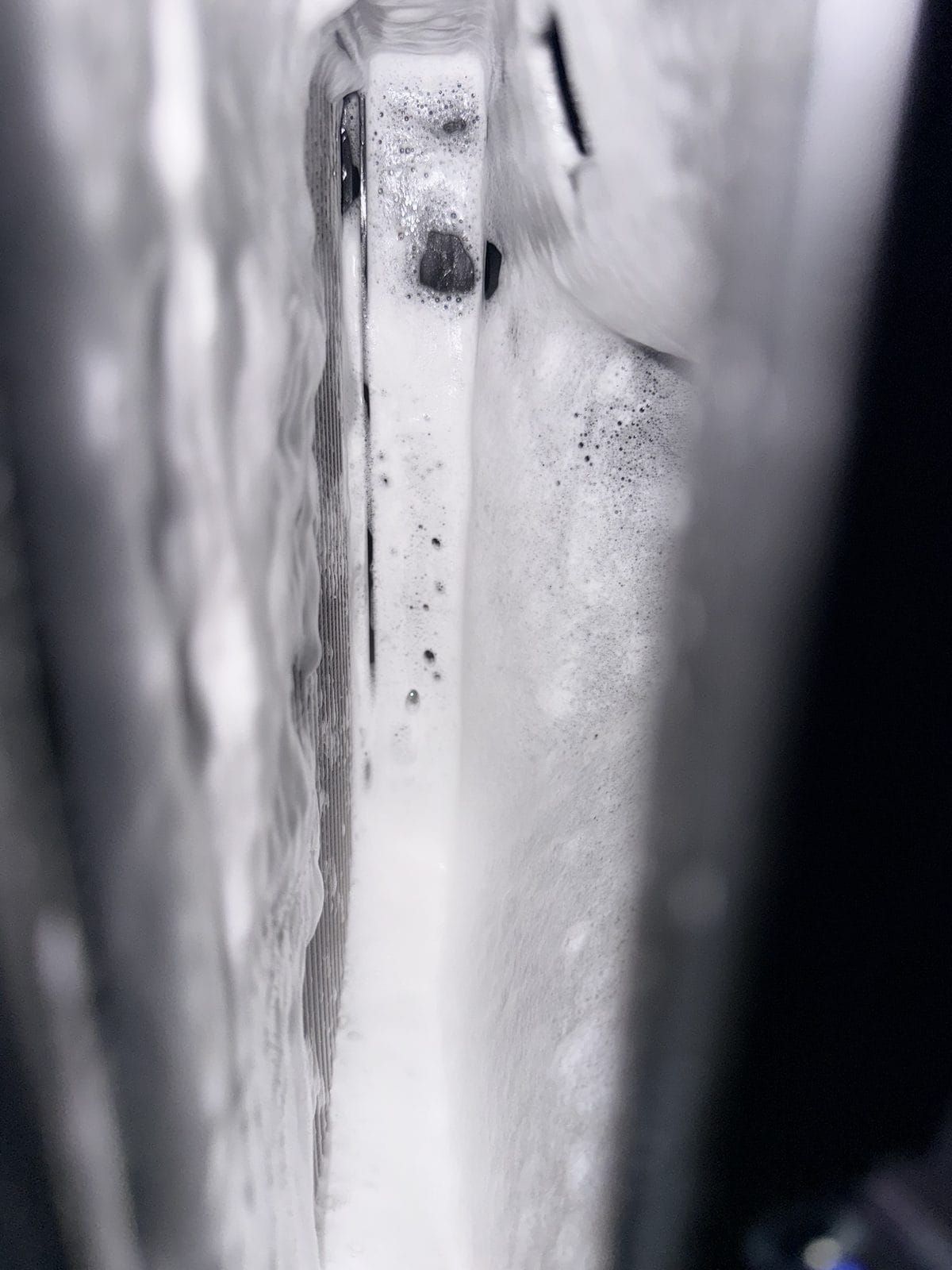 Kool-It foam cleaner covering the Model Y evaporator fins