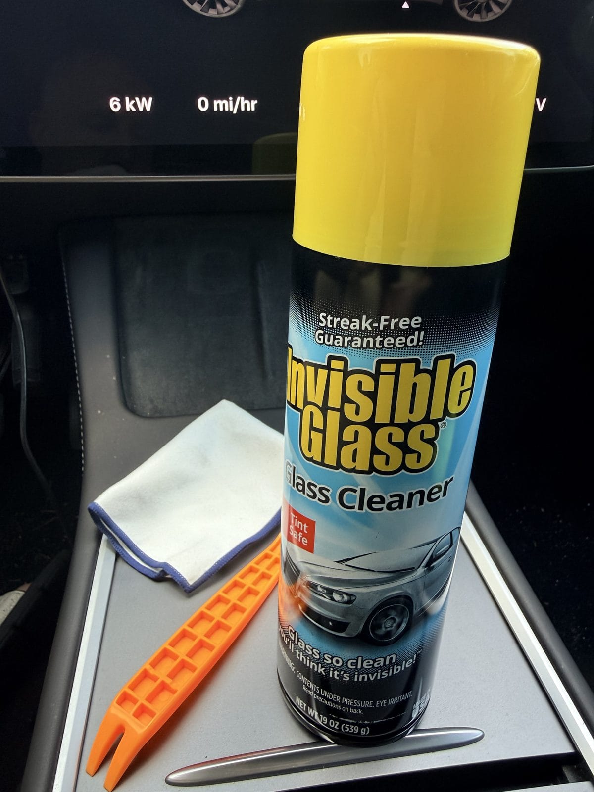 Tools to clean Tesla windshield cameras: Invisible Glass cleaner, microfiber cloth, and plastic trim removal tool