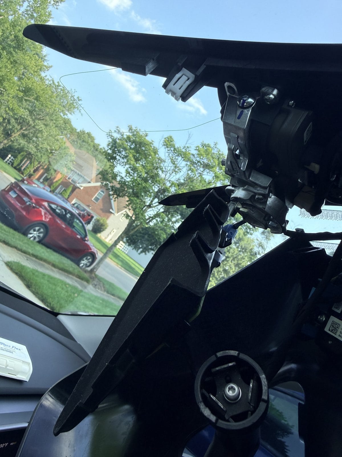 Open access to clean the Tesla windshield camera area with covers removed