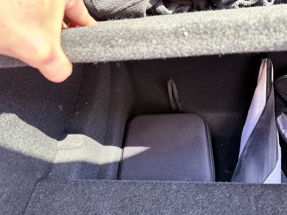 Tesla jack pads and tire repair kit stored in the under-floor bin of the trunk