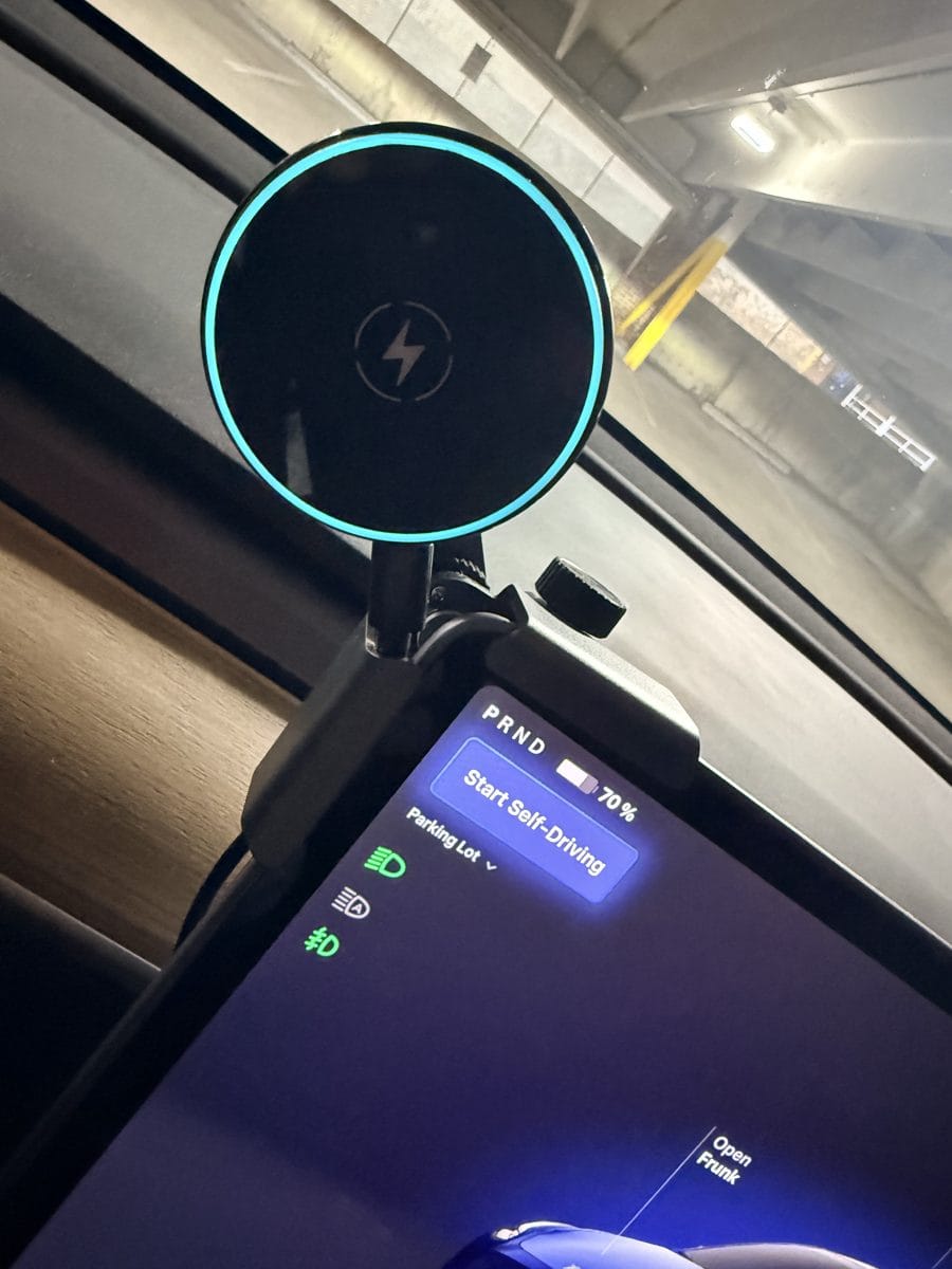 CloudValley wireless charging phone mount clamped to the top-left edge of a Tesla Model Y touchscreen