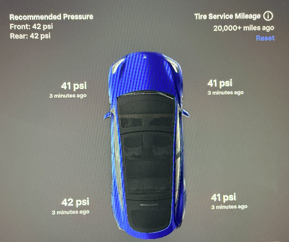 Tesla Model Y tire pressure screen showing Tire Service Mileage 20,000+ miles ago and the Reset button