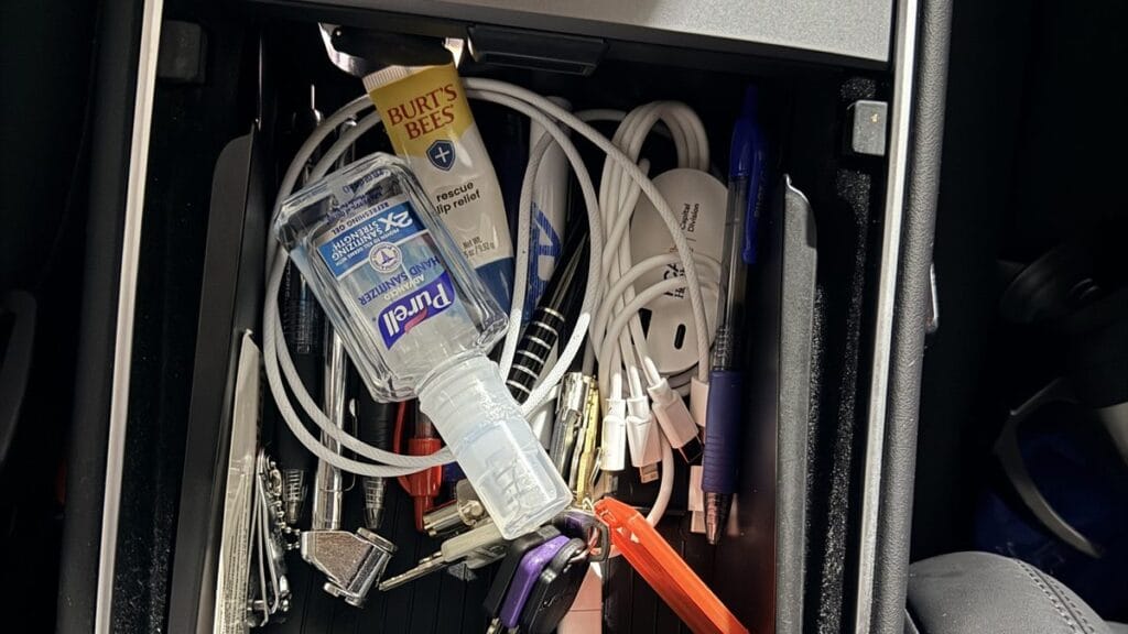 Open Tesla Model Y center console bin, the reason a Tesla phone mount and organizer exist