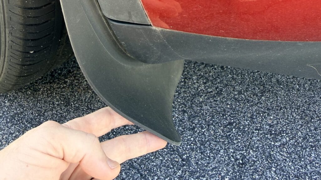 Tesla winter salt protection: flexible mud flap on a 2024 Model Y bent back by hand