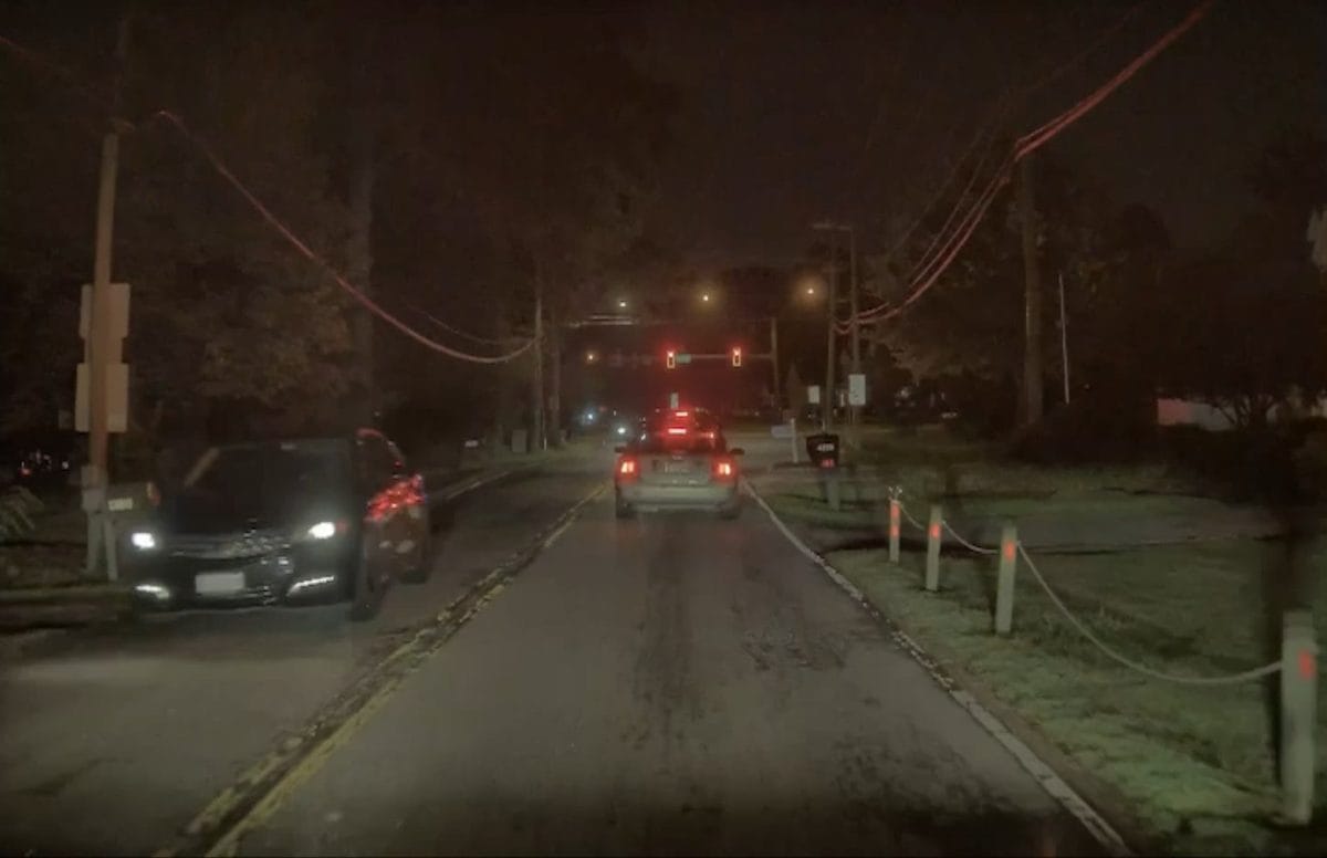 TeslaCam night footage where oncoming headlight glare washes out the front license plate